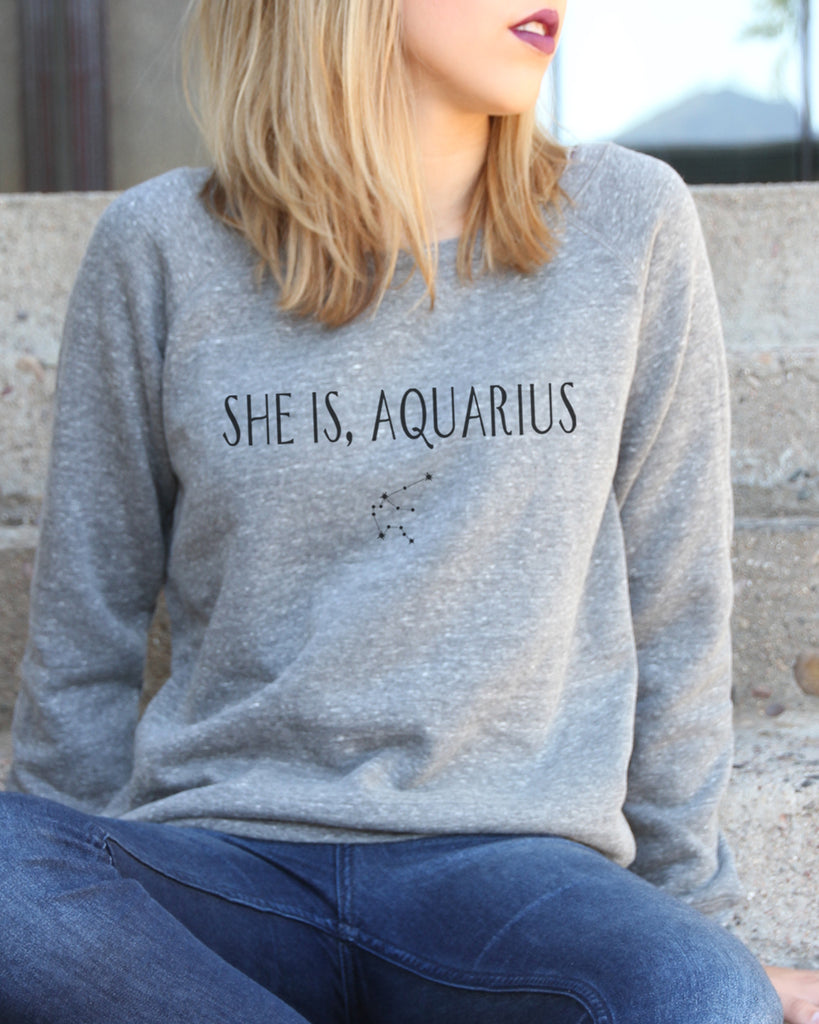 Close Up Model With "She Is, Aquarias" Sweatshirt Sitting On Stairs - It's Your Day Clothing